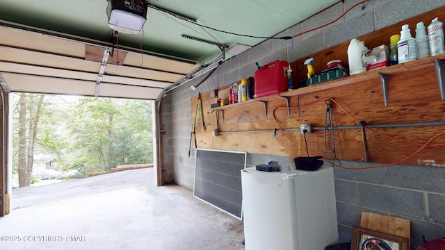 619 Rimrock Rd, Bartonsville, PA 18321 - garage featuring a garage door opener and concrete block wall
