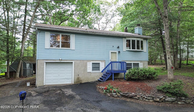 619 Rimrock Rd, Bartonsville, PA 18321 - view of front facade featuring a garage, a chimney, and driveway