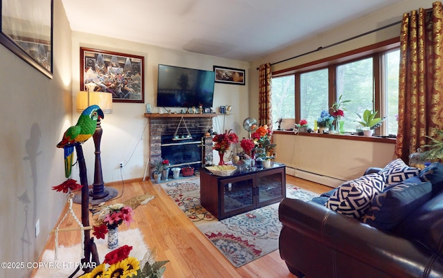 619 Rimrock Rd, Bartonsville, PA 18321 - living room with baseboard heating, wood finished floors, and a brick fireplace
