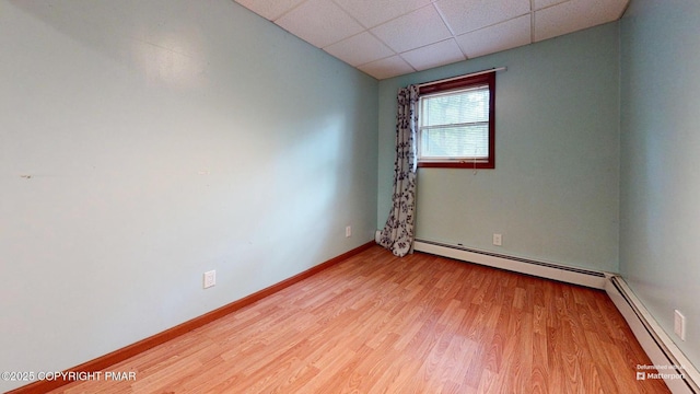 619 Rimrock Rd, Bartonsville, PA 18321 - spare room with a paneled ceiling, a baseboard radiator, and wood finished floors