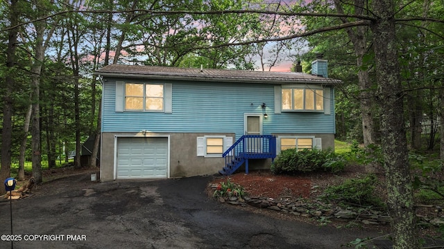 619 Rimrock Rd, Bartonsville, PA 18321 - view of front of property with a garage, a chimney, and asphalt driveway