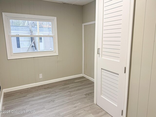 spare room with light wood finished floors and baseboards