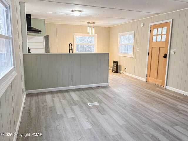 interior space featuring wood finished floors, visible vents, and baseboards