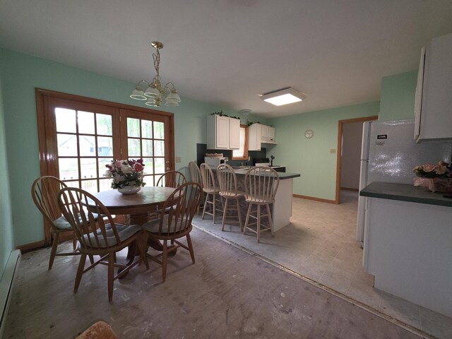131 Pine Dr, Pocono Lake, PA 18347 - dining room featuring a chandelier, a baseboard radiator, and baseboards