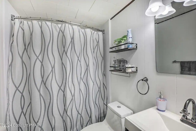 bathroom featuring toilet, a shower with curtain, and vanity