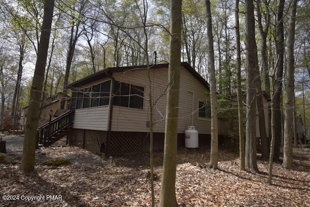 view of side of home with a sunroom