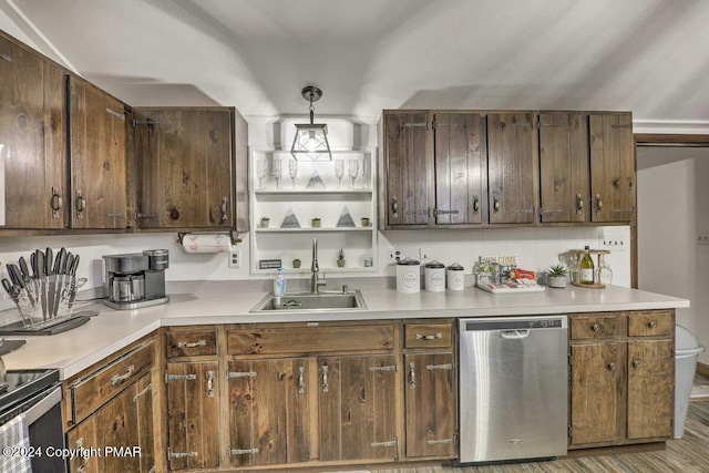 kitchen with a sink, pendant lighting, light countertops, and dishwasher