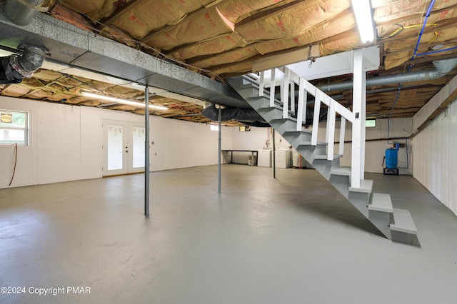 below grade area featuring stairs and washer / clothes dryer