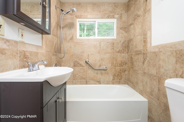 bathroom with toilet, tile walls, and vanity