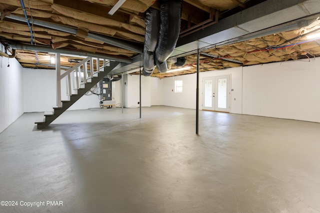 basement with stairs and heating unit