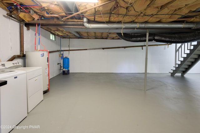 basement with washer and clothes dryer and electric water heater