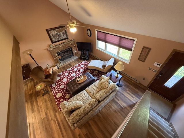 343 Echo Lake Rd, Tobyhanna, PA 18466 - living room with vaulted ceiling, wood finished floors, a ceiling fan, and a fireplace