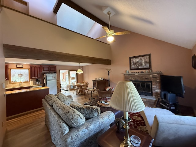 343 Echo Lake Rd, Tobyhanna, PA 18466 - living room featuring dark wood finished floors, a brick fireplace, ceiling fan, and high vaulted ceiling