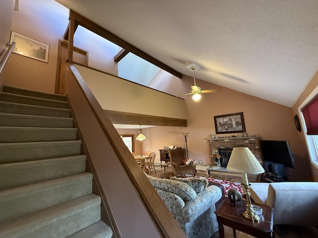 343 Echo Lake Rd, Tobyhanna, PA 18466 - living room with a textured ceiling, ceiling fan, vaulted ceiling, stairway, and a fireplace