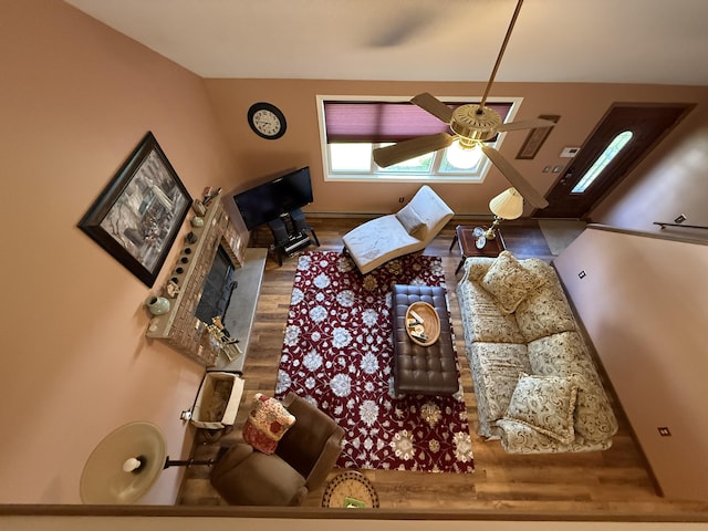 343 Echo Lake Rd, Tobyhanna, PA 18466 - living room with wood finished floors, a ceiling fan, and a fireplace