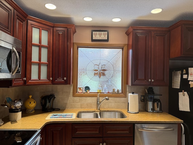 343 Echo Lake Rd, Tobyhanna, PA 18466 - kitchen featuring dark brown cabinets, light countertops, stainless steel appliances, and a sink