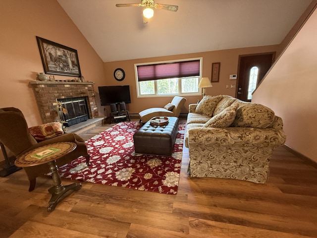343 Echo Lake Rd, Tobyhanna, PA 18466 - living area featuring lofted ceiling, wood finished floors, a fireplace, a ceiling fan, and baseboards