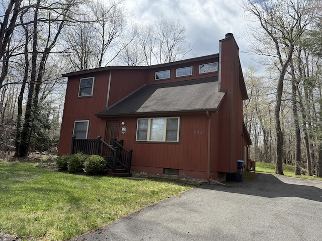 343 Echo Lake Rd, Tobyhanna, PA 18466 - rustic home featuring a chimney, a front yard, and roof with shingles
