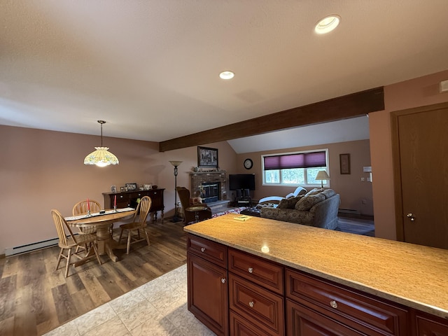 343 Echo Lake Rd, Tobyhanna, PA 18466 - kitchen with a brick fireplace, open floor plan, light countertops, baseboard heating, and hanging light fixtures