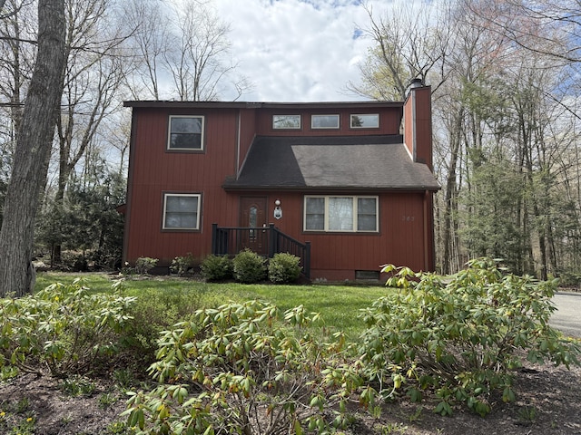 343 Echo Lake Rd, Tobyhanna, PA 18466 - view of front facade featuring roof with shingles, a chimney, and a front yard