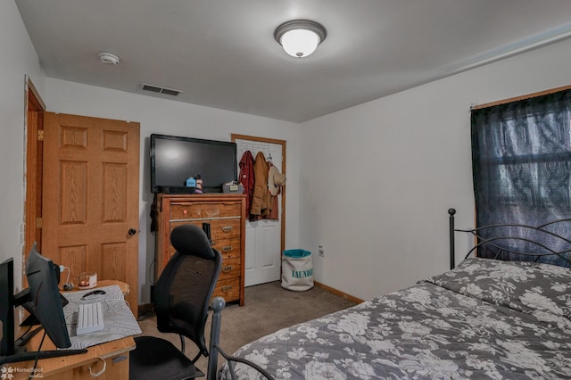 bedroom with baseboards, visible vents, and carpet
