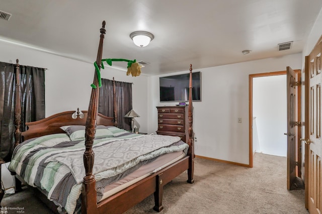 bedroom with visible vents, baseboards, and light carpet