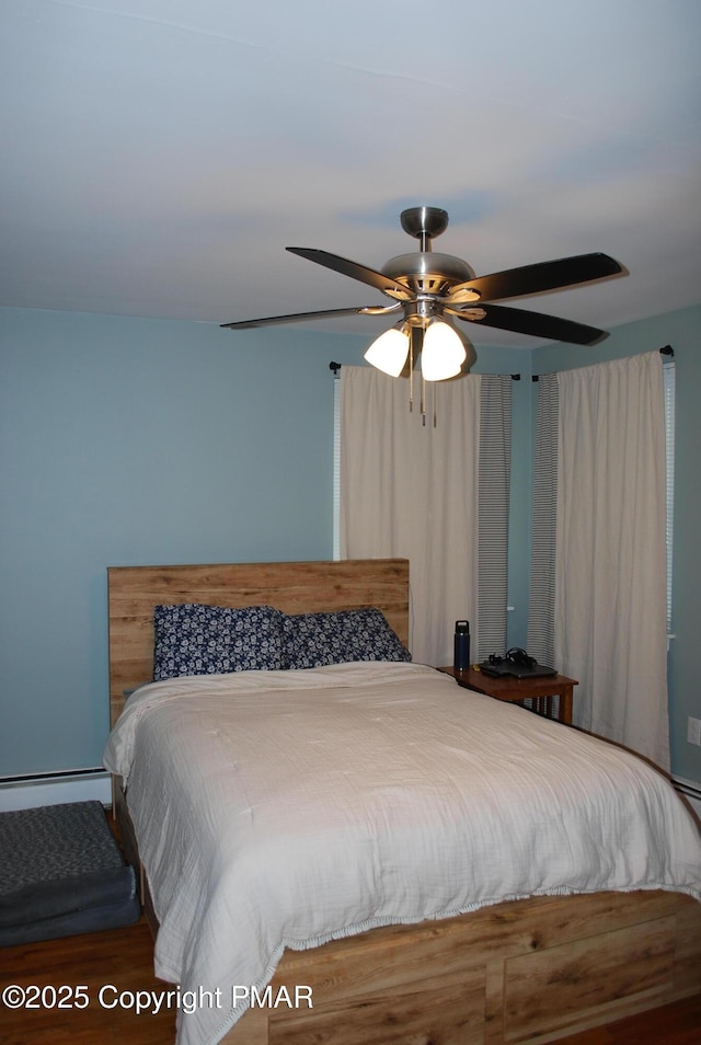 bedroom with ceiling fan and baseboard heating