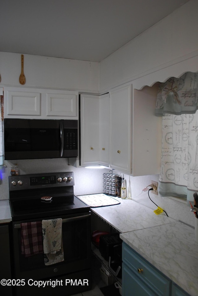 kitchen featuring blue cabinets, black range with electric stovetop, and white cabinets