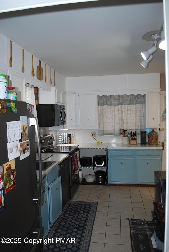 kitchen featuring light tile patterned floors, ceiling fan, white cabinetry, black appliances, and blue cabinets