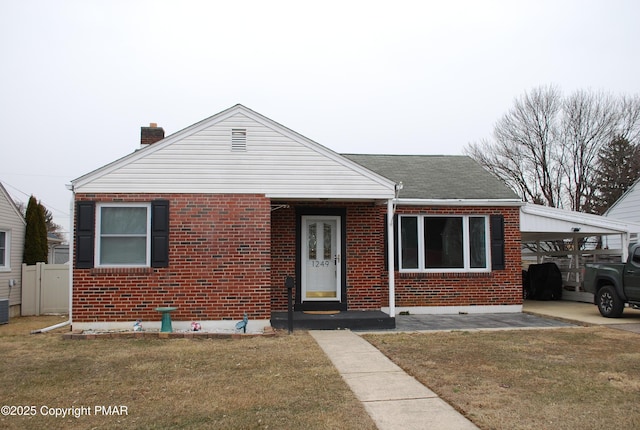 view of front of property featuring a carport and a front lawn