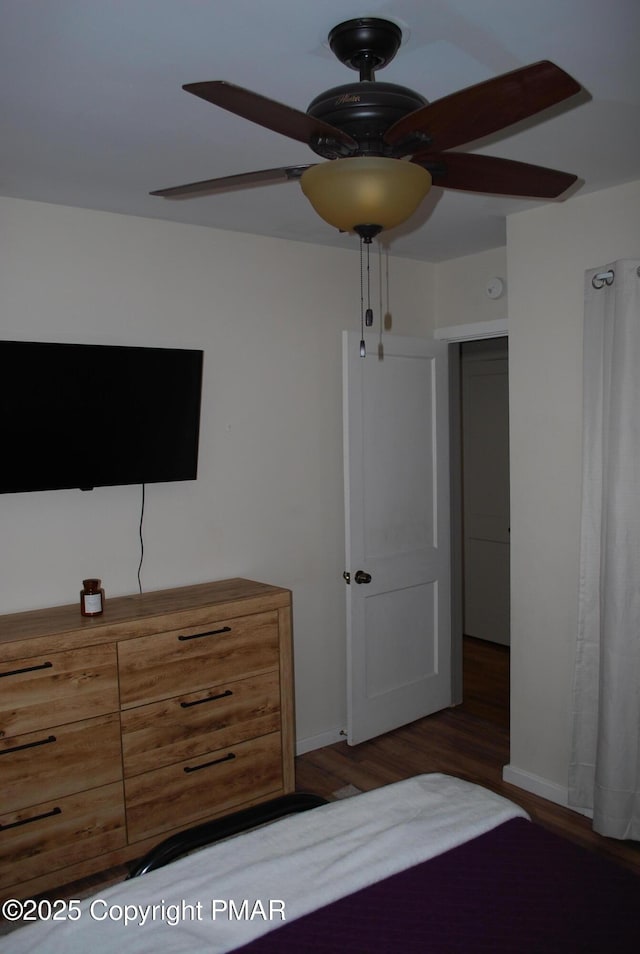 unfurnished bedroom featuring ceiling fan and dark hardwood / wood-style floors