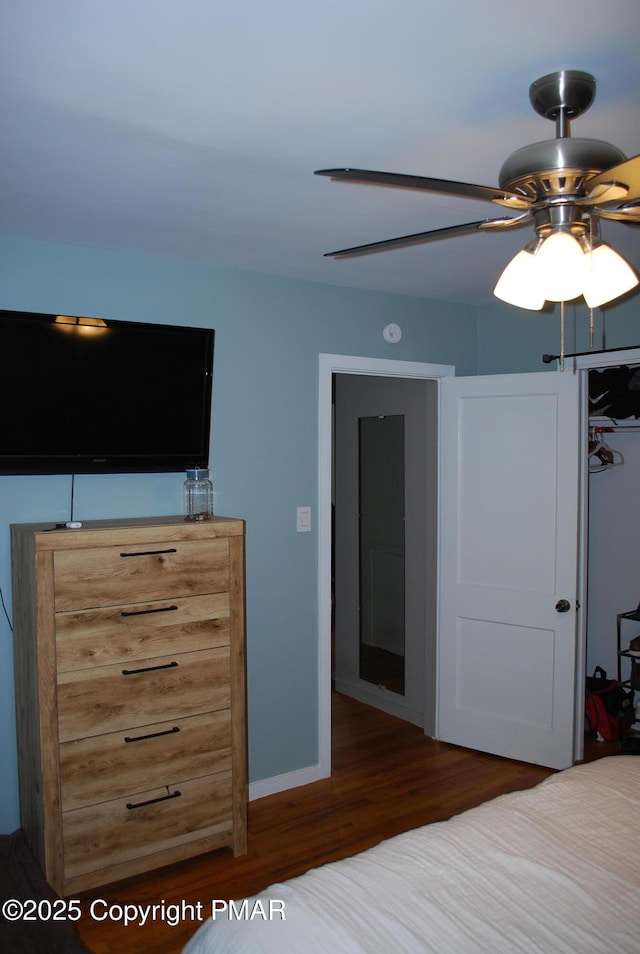 unfurnished bedroom featuring ceiling fan and dark hardwood / wood-style floors