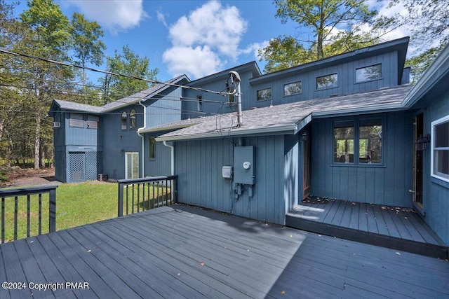 wooden deck featuring a yard