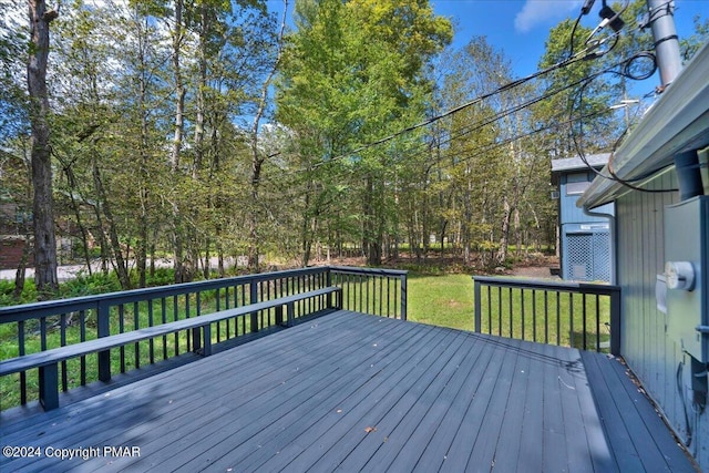 wooden terrace featuring a yard