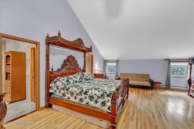 bedroom with a baseboard heating unit, baseboards, wood finished floors, and vaulted ceiling