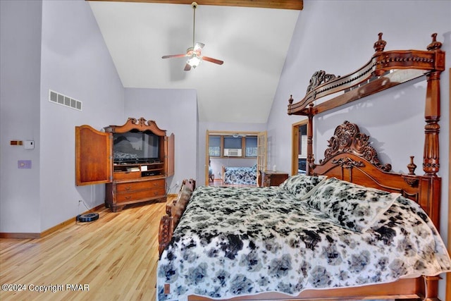 bedroom featuring a ceiling fan, wood finished floors, visible vents, high vaulted ceiling, and baseboards