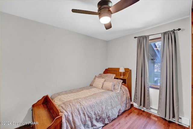 bedroom with a ceiling fan and wood finished floors