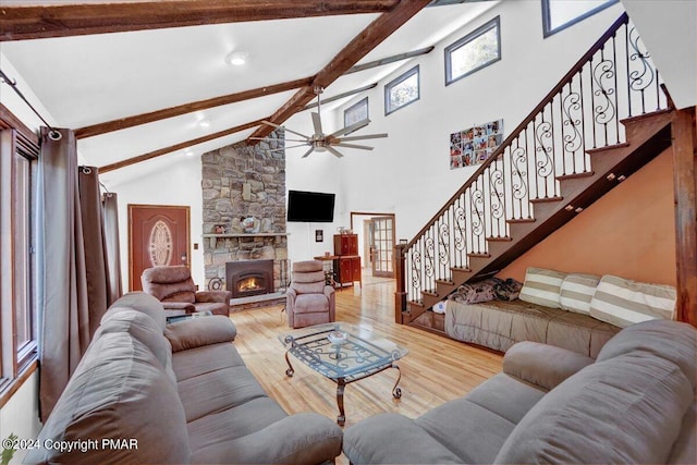 living area featuring beam ceiling, stairway, wood finished floors, and ceiling fan