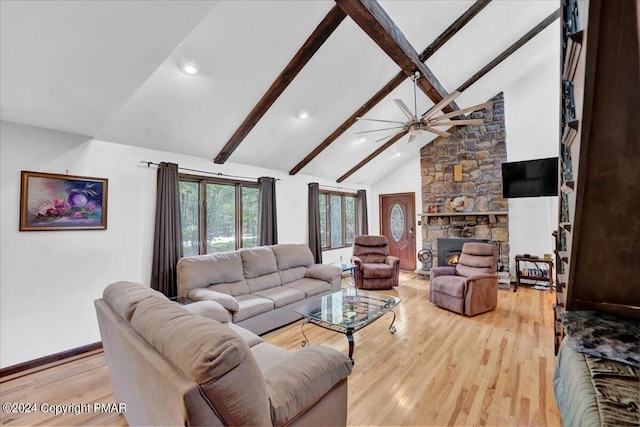 living room featuring a ceiling fan, baseboards, light wood finished floors, high vaulted ceiling, and beamed ceiling