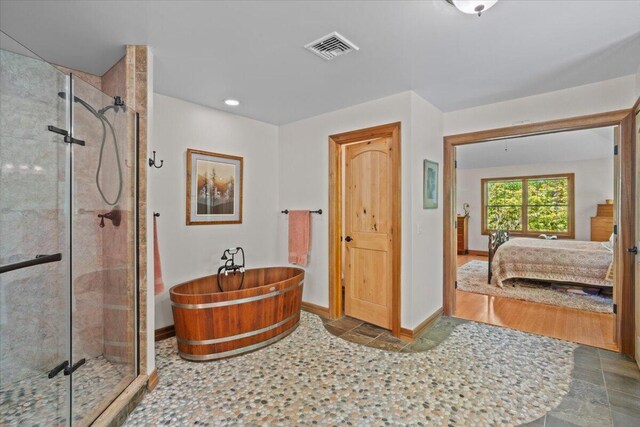 127 Timber Lake Dr, Canadensis, PA 18325 - full bath featuring ensuite bath, a freestanding bath, a shower stall, baseboards, and recessed lighting