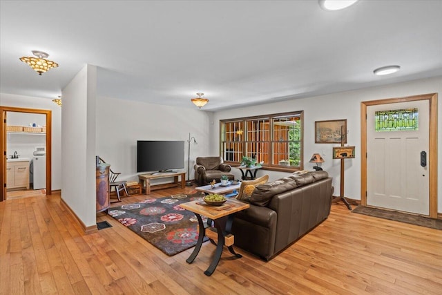 127 Timber Lake Dr, Canadensis, PA 18325 - living area featuring light wood-style floors, washer / clothes dryer, and baseboards