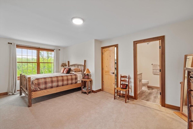 127 Timber Lake Dr, Canadensis, PA 18325 - bedroom with light colored carpet, baseboards, and connected bathroom