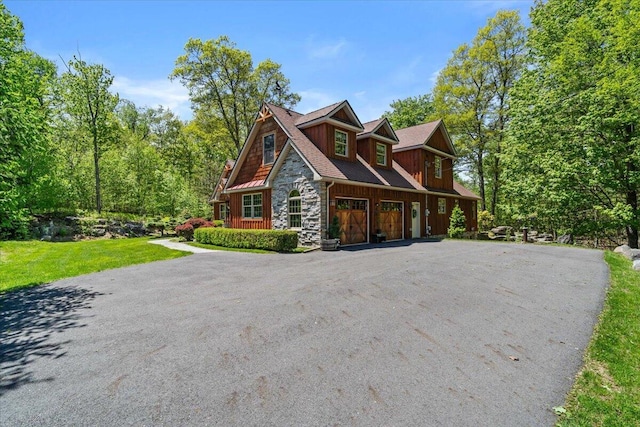 127 Timber Lake Dr, Canadensis, PA 18325 - view of front of home featuring stone siding, a garage, driveway, and a front yard