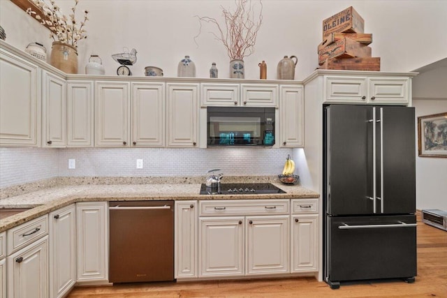 127 Timber Lake Dr, Canadensis, PA 18325 - kitchen featuring black appliances, backsplash, light wood finished floors, and light stone countertops