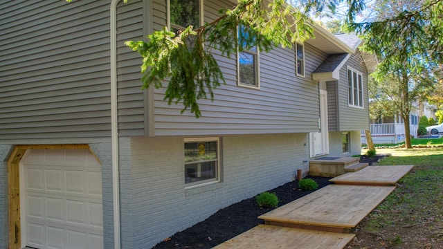 36 Cobblewood Dr, Mount Pocono, PA 18344 - view of side of property with an attached garage and brick siding