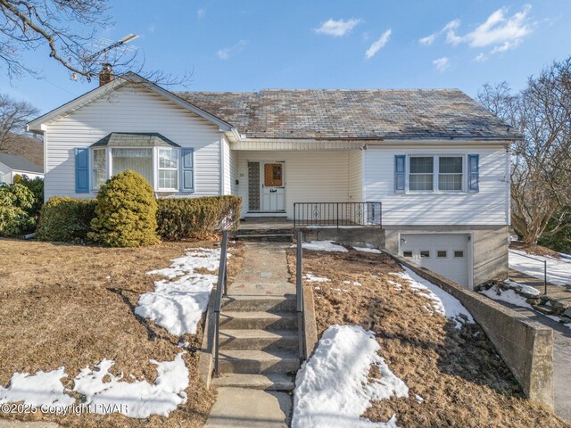 view of front of home featuring a garage and a porch