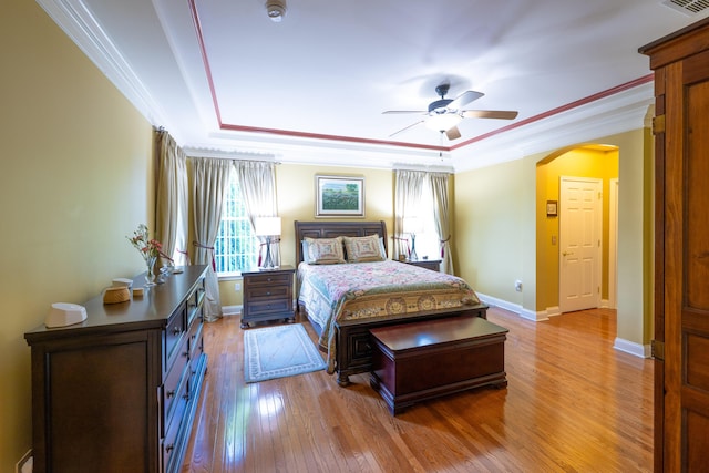 2772 Sheffield Dr, Easton, PA 18040 - bedroom with arched walkways, wood finished floors, crown molding, a tray ceiling, and a ceiling fan
