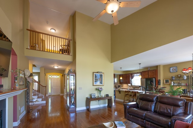 2772 Sheffield Dr, Easton, PA 18040 - living room featuring dark wood finished floors, a towering ceiling, a ceiling fan, and stairway