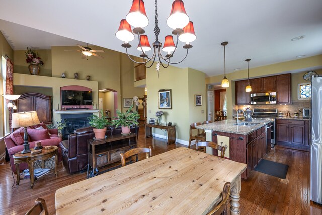 2772 Sheffield Dr, Easton, PA 18040 - dining area with a ceiling fan, dark wood-type flooring, a glass covered fireplace, a chandelier, and arched walkways