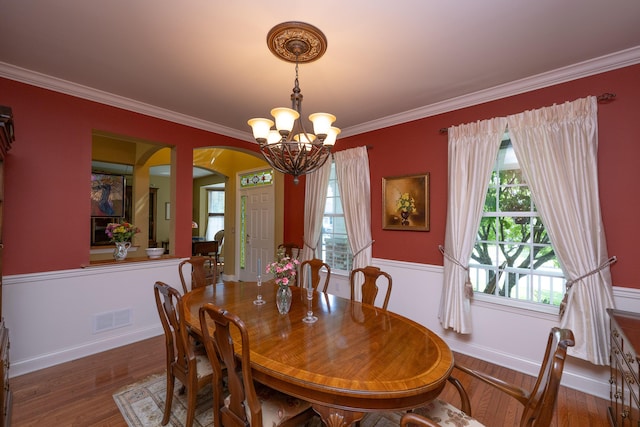 2772 Sheffield Dr, Easton, PA 18040 - dining space with a chandelier, arched walkways, crown molding, and wood finished floors